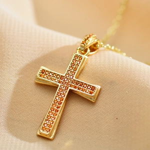 Gold-plated cross necklace with vibrant orange cubic zirconia in a micro-pave setting