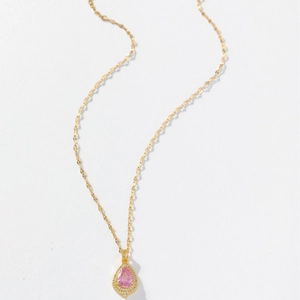 Elegant gold-tone teardrop necklace featuring a pink gemstone and micro-pave crystals