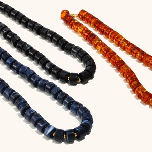 18K gold plated necklace with amber, black, and blue marble resin cylindrical beads