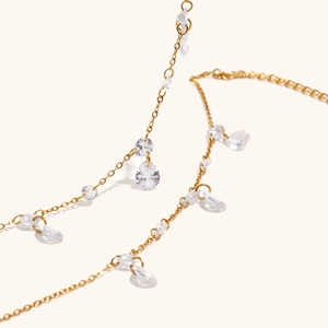 Detail of 18K gold-plated chain with pear-cut zircon pendants and sparkling round stones