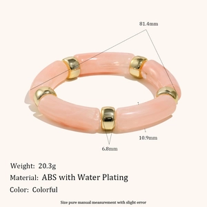 Pink and gold acrylic bamboo-style stretch bracelet with polished metallic spacers