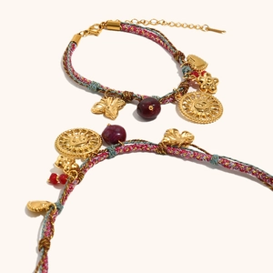 Multicolor woven bracelet with 18K gold sun, heart, flower, and butterfly charms
