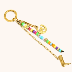 18K gold plated horseshoe and boot keychain with colorful beads on white background