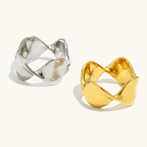 Dettaglio di anelli a onde intrecciate in acciaio inossidabile oro 18K e argento