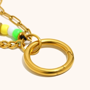 Detail of 18K gold plated horseshoe keychain with colorful beads and spring ring clasp