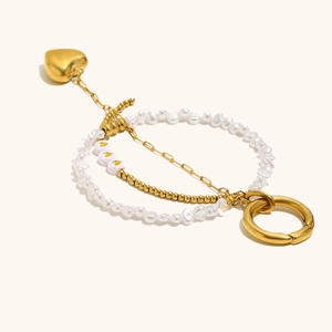 Detail of 18K gold-plated heart pendant with pearl chain and minimalist gold bead accents