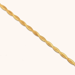 Close-up of golden double-strand braided herringbone chain with polished finish