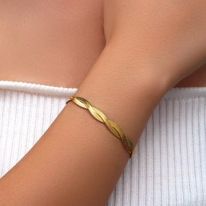Close-up of golden braided flat snake chain bracelet with elegant twisted texture for women