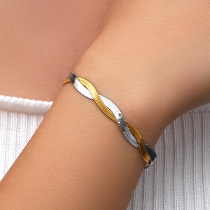 Detail of a two-tone twisted flat snake chain bracelet in gold and silver on a wrist