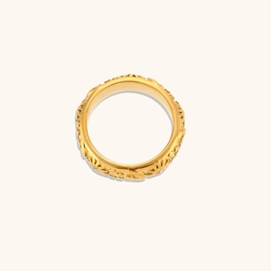 Detailed view of sunburst textured 18K gold plated ring with white zircon crystal inlay