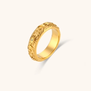 Detail view of vintage 18K gold plated ring with engraved moon star sun patterns and zircon
