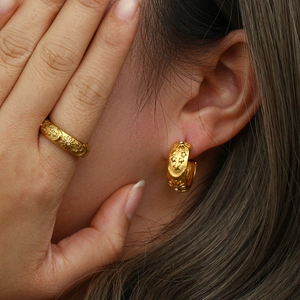 Detail of vintage 18K gold plated ring and earrings with sun, moon and star motifs