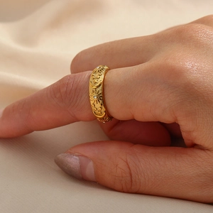 Detail of vintage 18K gold plated ring with engraved celestial motifs and zircons
