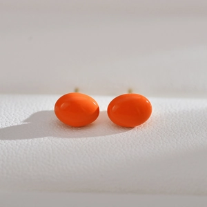 Minimalist bright orange oval stud earrings with shiny finish and gold metal posts