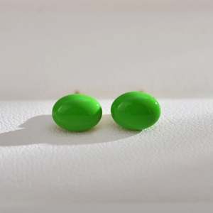 Elegant oval neon green freshwater pearl stud earrings on white textured background