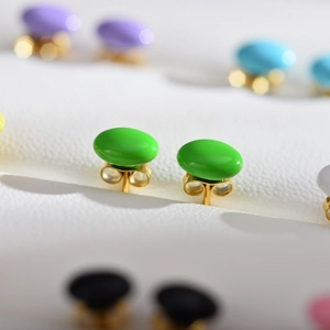 Macro shot of minimalist bright green pearl stud earrings with colorful options