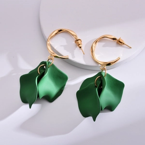 Detail of elegant gold metal hoops with layered matte dark green resin rose petals