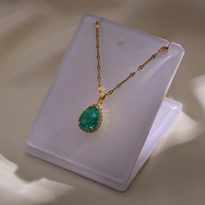 Detailweergave van de ketting met peergeslepen groene edelsteen en zirkonia halo op goud