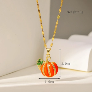 Detail of orange pumpkin pendant necklace with white zircons and green leaf charm