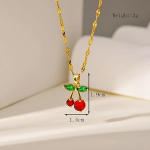 Macro shot of 18K gold cherry earrings with red stones and size dimension markings