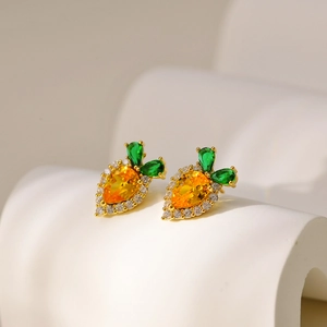 Detailed close-up of cute carrot earrings featuring orange and green sparkling crystals