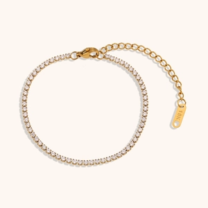 Macro view of 18K gold-plated tennis bracelet with lobster clasp and zircons