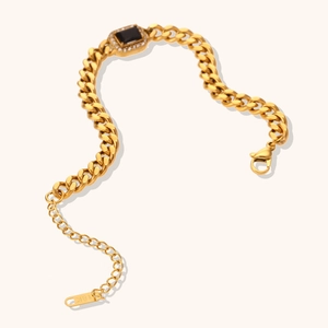 Detail of 18K gold plated Cuban chain bracelet with rectangle black stone and zircons