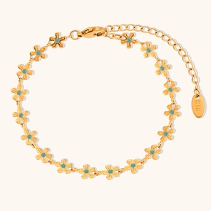 Detail of gold floral bracelet with turquoise beads and 18K gold hallmark tag