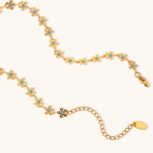 Gold plated stainless steel necklace with blue enamel flower charms and lobster clasp