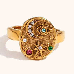 Macro view of gold hammered ring featuring celestial motifs with colorful zircon stones