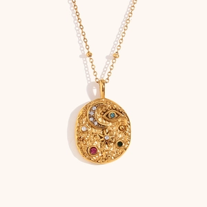 Gold celestial coin necklace featuring evil eye, moon, star motifs and colorful crystals