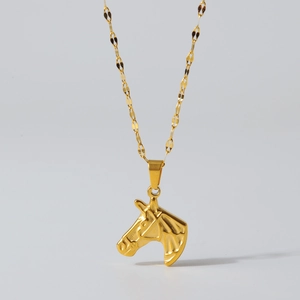 Detailed close-up of 18K gold stainless steel necklace with textured horse head pendant