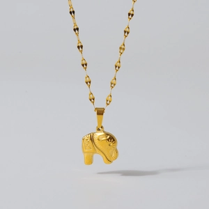 Detailed shot of an elephant pendant necklace with textured 18K gold plated stainless steel