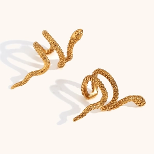 Close-up of gold snake ear cuff featuring detailed scale texture and spiral design
