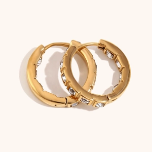 Detailed view of 18K gold plated hoop earrings with inlaid clear square zirconia crystals