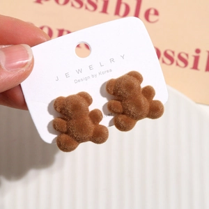 Cute brown velvet flocking bear stud earrings displayed on jewelry card