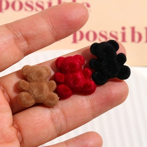 Close-up of DIY velvet flocked mini bear charms in brown, red, and black for jewelry