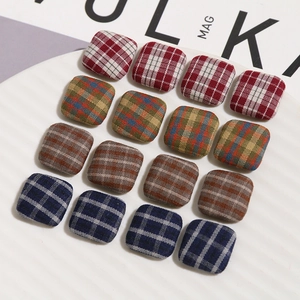 Close-up of square fabric plaid buttons and DIY accessories for hair clips and fashion