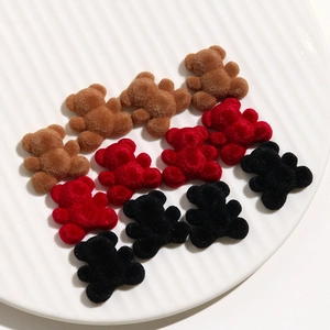 Detail of brown, red, and black flocked resin bears for DIY jewelry and hair accessories