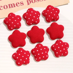 Macro shot of red polka dot and striped star fabric buttons for DIY hair accessories