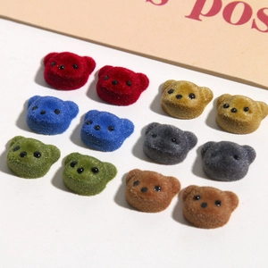 Close-up of colorful flocked bear head resin patches for DIY jewelry making