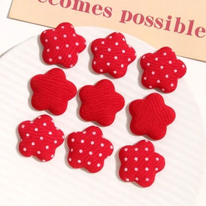 Macro detail of red star fabric buttons with polka dots and stripes for DIY crafts