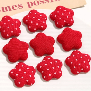 Detailed view of red fabric flower patches with polka dots for DIY hair accessories