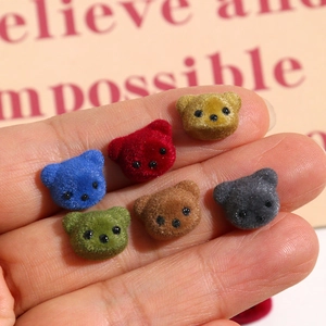 Macro shot of colorful flocked mini bear heads for DIY handmade jewelry and nail art crafts