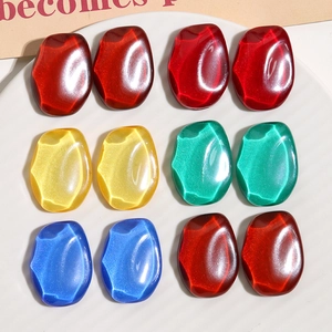 Detailed close-up of colorful resin rhombic beads with shimmering stone texture for jewelry DIY