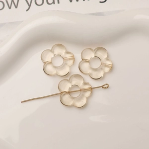 Vue macro de perles fleurs en acrylique ambré avec tige métallique pour bijoux DIY