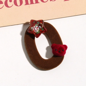 Detail of Christmas plush bear hair tie with red sequin star and soft brown velvet band