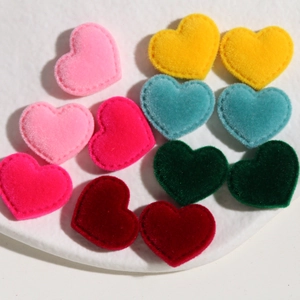 Colorful heart-shaped flocked patches for DIY clothing and hair accessories in a white tray