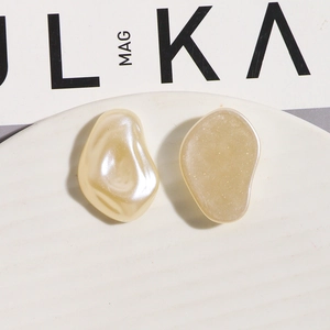 Detail of irregular faux pearl acrylic charms in pearl beige and matte frosted finish
