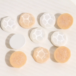 Detailed view of geometric resin shoe buckles with wave texture and smooth semi-circle finish